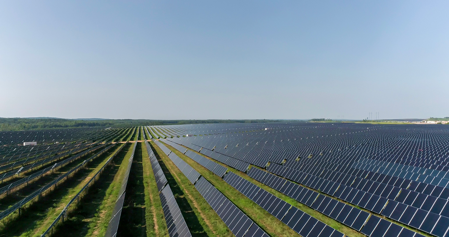 Side view of solar panel rows capturing sunlight at the GA Solar 4 solar farm.