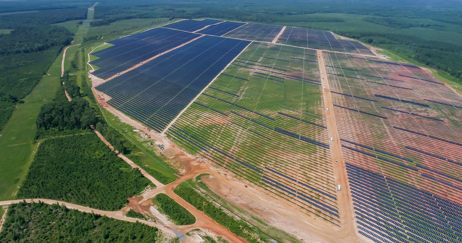 Aerial view of GA Solar 4 project showcasing rows of solar panels surrounded by greenery.