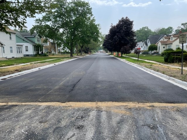 Completed road surface on Leahy Street in Muskegon Heights with new curbs and driveways.