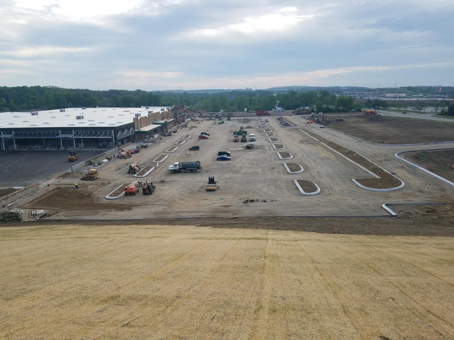 Newly paved parking lot and landscaping work in progress at the Menards development site.